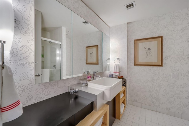 bathroom featuring tile patterned flooring, vanity, and an enclosed shower