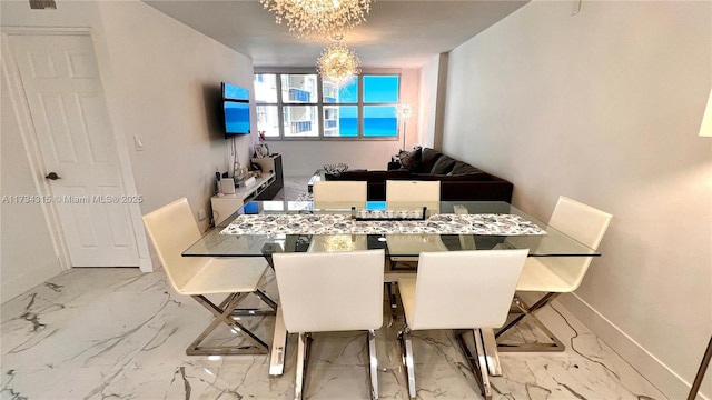 dining space featuring an inviting chandelier