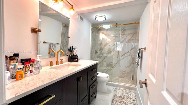 bathroom featuring vanity, toilet, and an enclosed shower