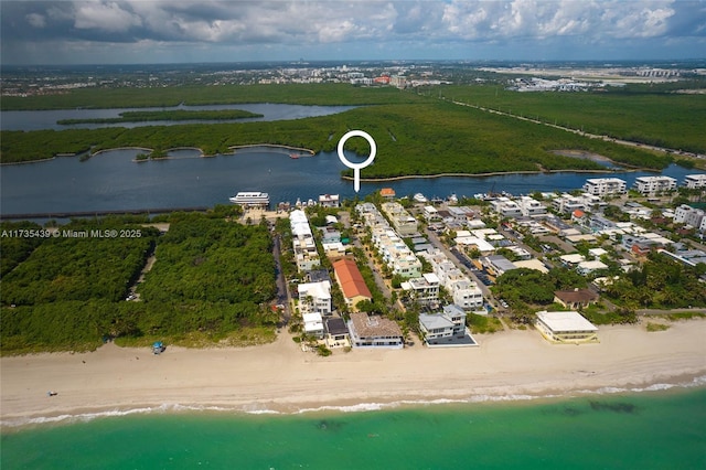 bird's eye view with a water view and a view of the beach