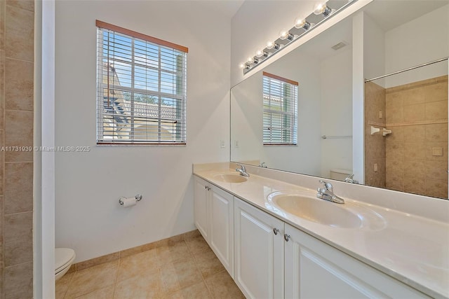 bathroom with vanity, walk in shower, tile patterned floors, and toilet