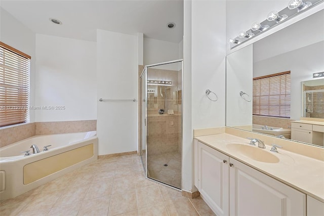 bathroom with tile patterned floors, independent shower and bath, and vanity