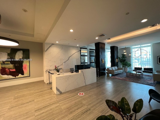 dining room featuring a chandelier and a wall of windows