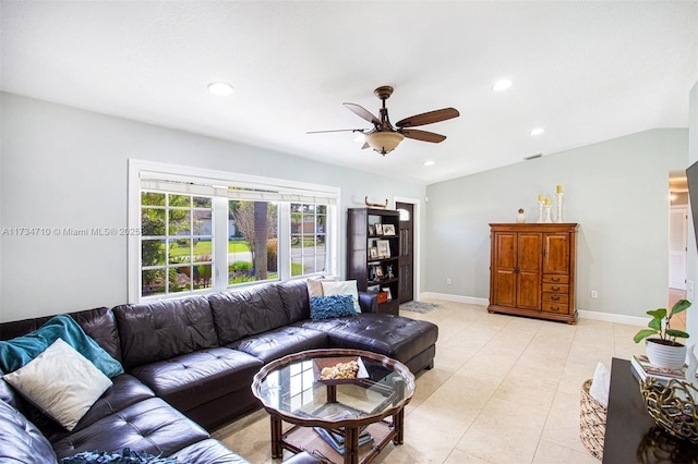 living room featuring lofted ceiling, light tile patterned floors, and ceiling fan