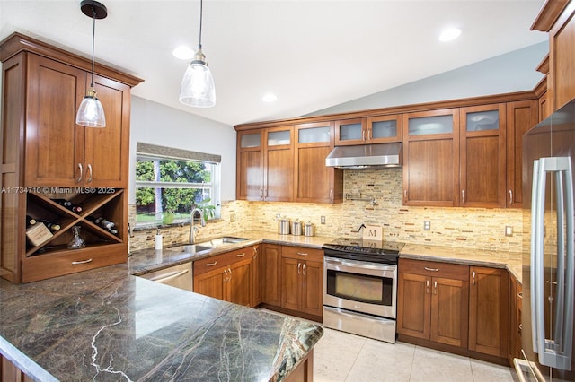 kitchen featuring pendant lighting, sink, kitchen peninsula, and appliances with stainless steel finishes