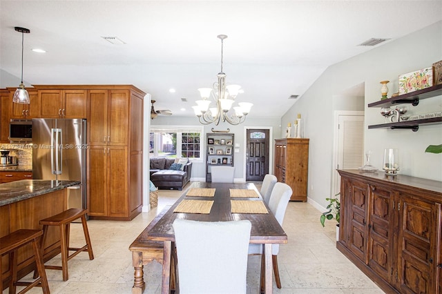 dining area featuring lofted ceiling and a notable chandelier