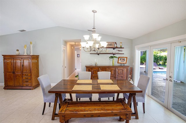 dining room featuring lofted ceiling, a notable chandelier, and french doors