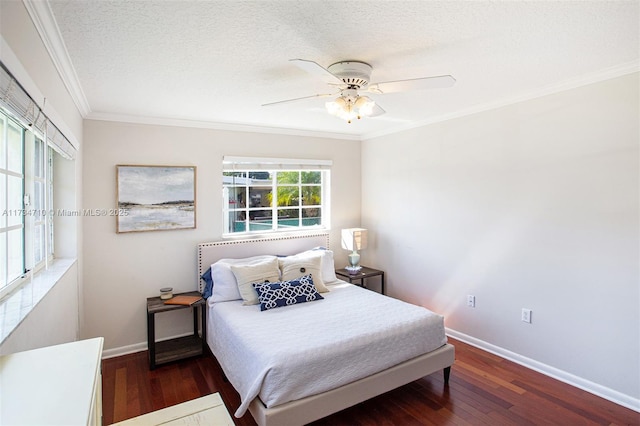 bedroom featuring ceiling fan, ornamental molding, dark hardwood / wood-style floors, and a textured ceiling