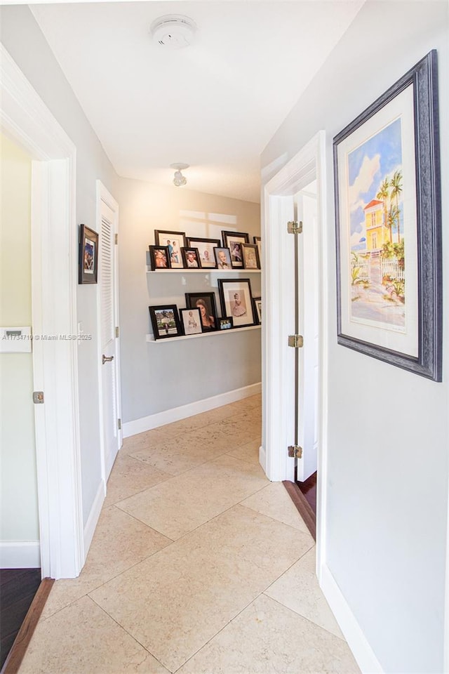 corridor with light tile patterned flooring