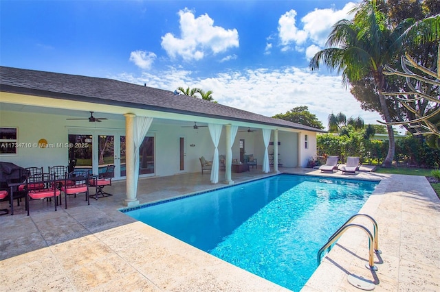 view of swimming pool featuring a patio area and ceiling fan