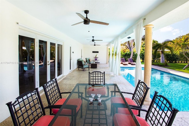 view of pool with a patio and ceiling fan