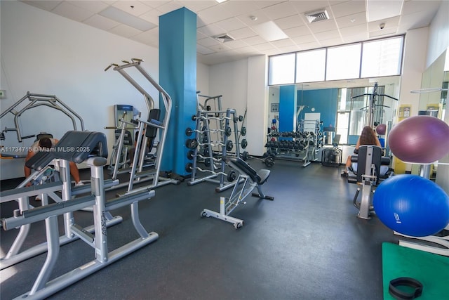 exercise room featuring a paneled ceiling