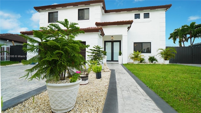 mediterranean / spanish-style house featuring a front lawn