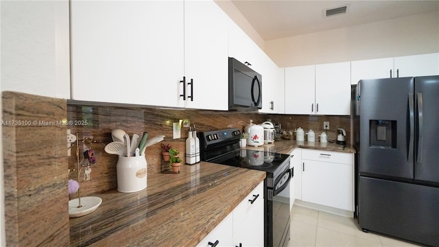 kitchen with white cabinetry, light tile patterned flooring, tasteful backsplash, and black appliances