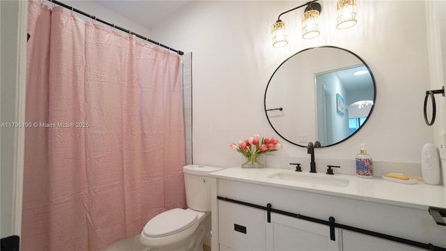 bathroom featuring walk in shower, vanity, and toilet