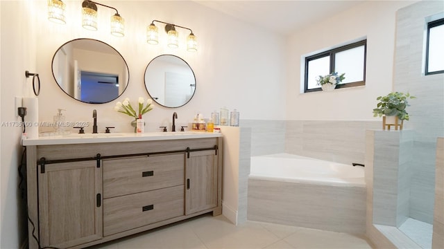 bathroom with vanity, tiled bath, and tile patterned floors