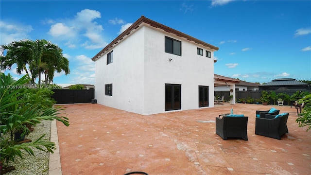 rear view of property featuring an outdoor hangout area and a patio area