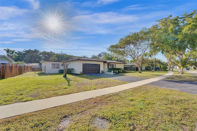 single story home with a garage and a front lawn