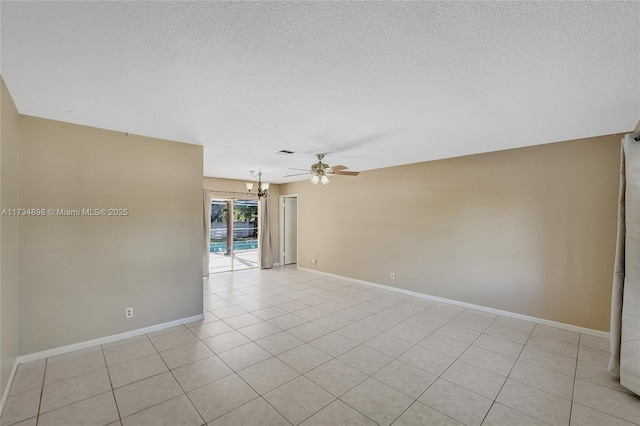 tiled empty room featuring ceiling fan with notable chandelier and a textured ceiling