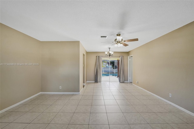 tiled spare room featuring ceiling fan with notable chandelier and a textured ceiling