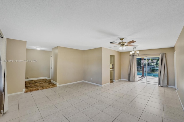 spare room with light tile patterned flooring, ceiling fan with notable chandelier, and a textured ceiling