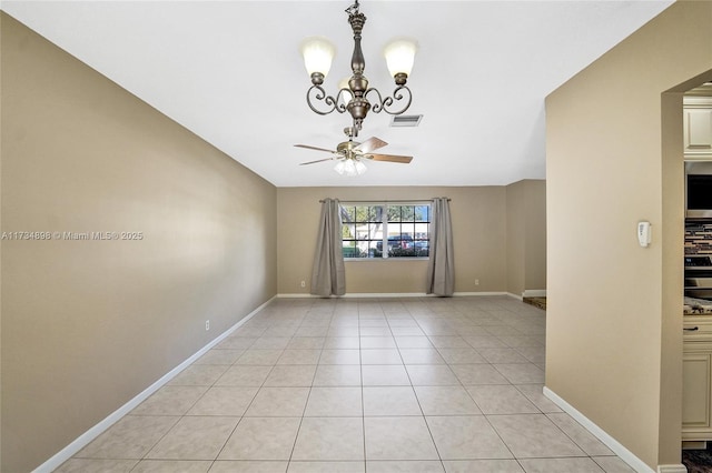 unfurnished room with ceiling fan with notable chandelier and light tile patterned floors