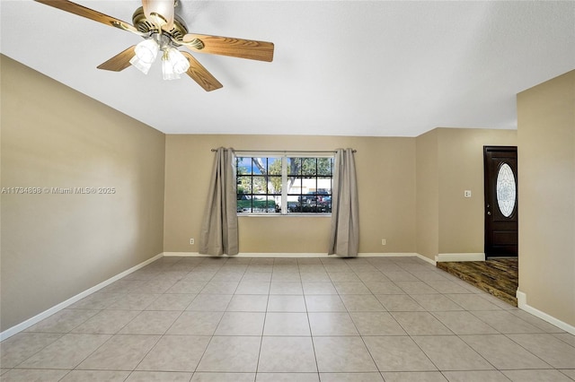 tiled foyer featuring ceiling fan