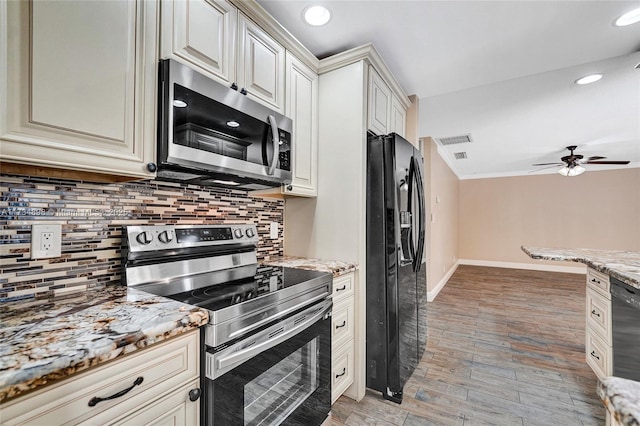 kitchen with light stone counters, tasteful backsplash, light hardwood / wood-style flooring, ceiling fan, and black appliances