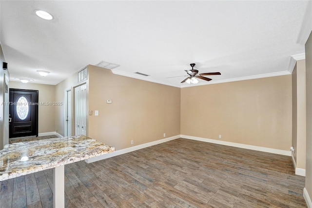 foyer featuring ornamental molding, dark hardwood / wood-style floors, and ceiling fan