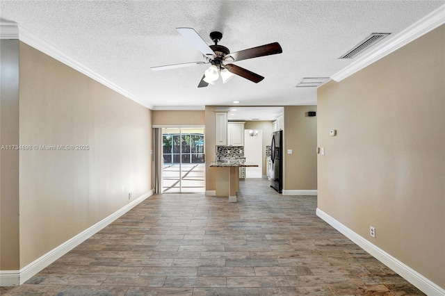 unfurnished living room featuring a textured ceiling, ornamental molding, ceiling fan, and light wood-type flooring