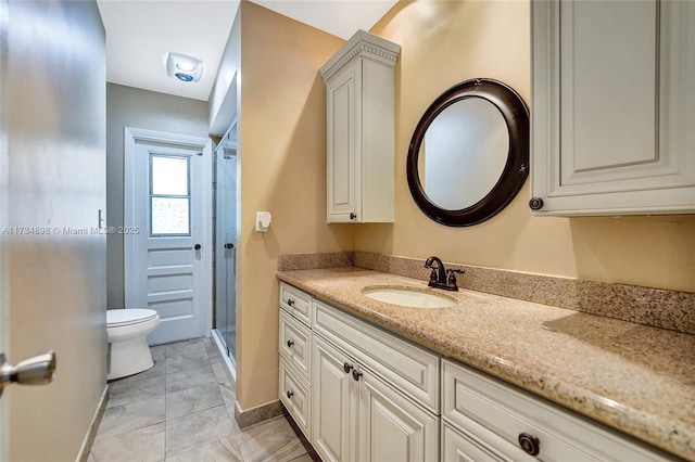 bathroom featuring vanity, a shower, and toilet