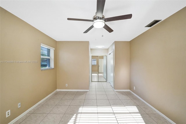 spare room featuring light tile patterned floors and ceiling fan