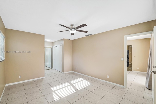 unfurnished room with light tile patterned flooring and ceiling fan