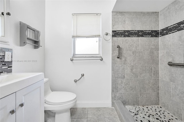 bathroom with toilet, tasteful backsplash, a tile shower, vanity, and tile patterned flooring