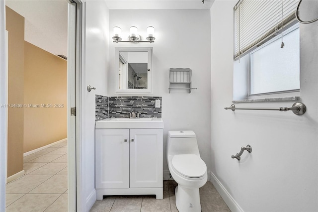 bathroom with tile patterned flooring, backsplash, vanity, and toilet