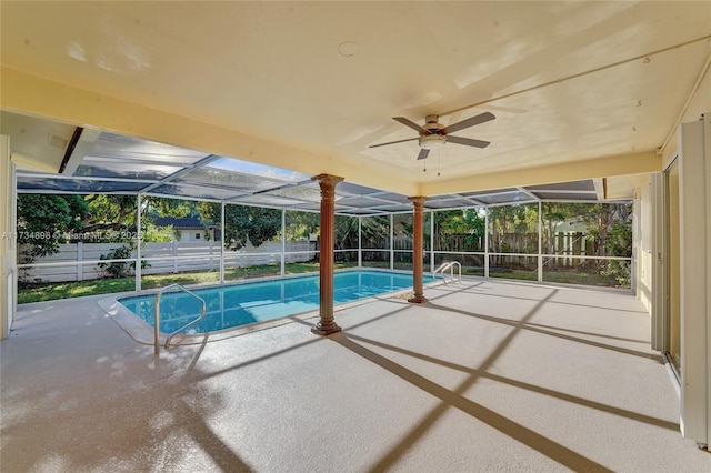 view of swimming pool with glass enclosure and a patio area