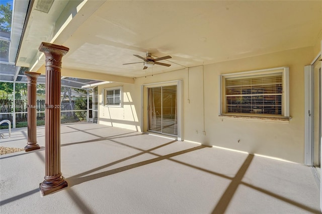 view of patio / terrace featuring ceiling fan and glass enclosure