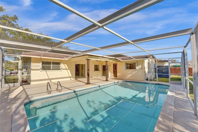 view of swimming pool with a patio area and glass enclosure