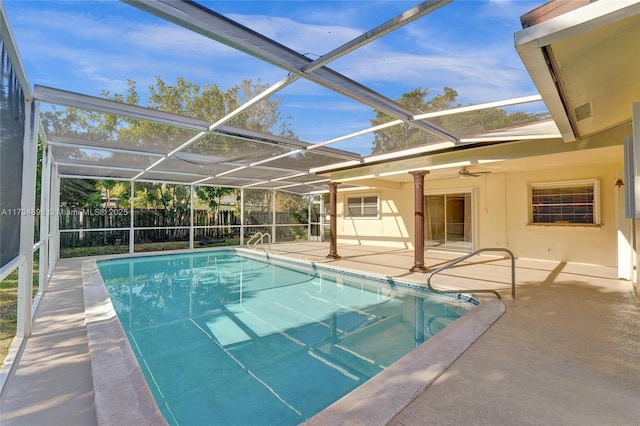 view of pool featuring glass enclosure and a patio area