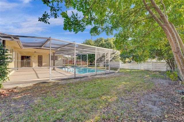 view of yard featuring a patio, a fenced in pool, and glass enclosure