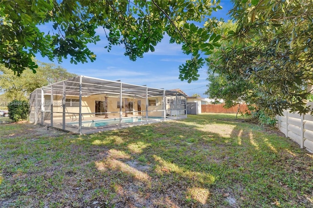 view of yard with a fenced in pool and glass enclosure