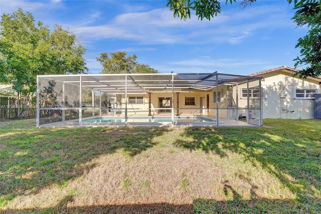 rear view of property featuring a yard, a lanai, a fenced in pool, and a patio area