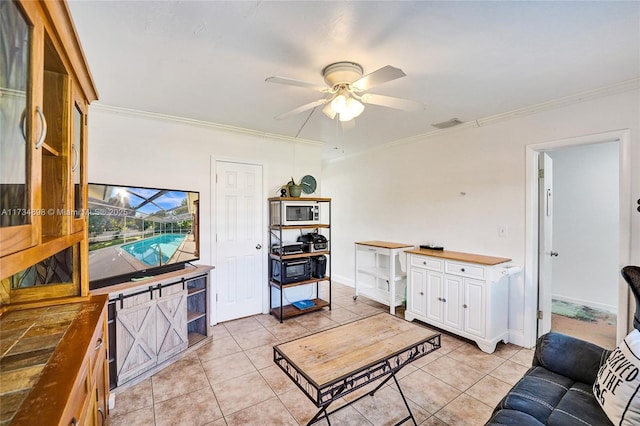 living room featuring crown molding, ceiling fan, and light tile patterned floors