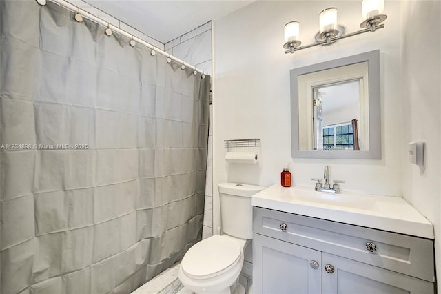 bathroom with vanity, curtained shower, and toilet