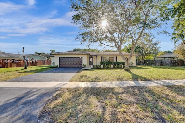 ranch-style house with a garage and a front lawn