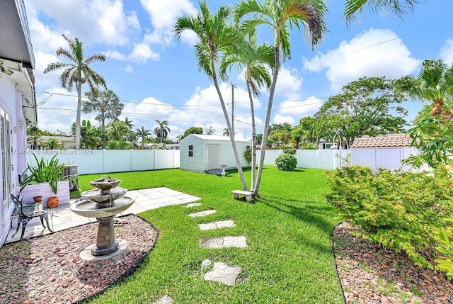 view of yard with a storage unit, a patio, and central air condition unit