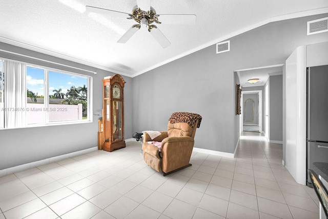 sitting room with light tile patterned flooring, vaulted ceiling, a textured ceiling, ornamental molding, and ceiling fan