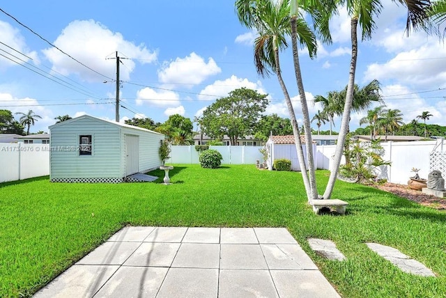 view of yard featuring a patio and an outbuilding