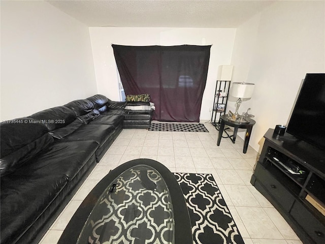 living room featuring a textured ceiling and light tile patterned flooring