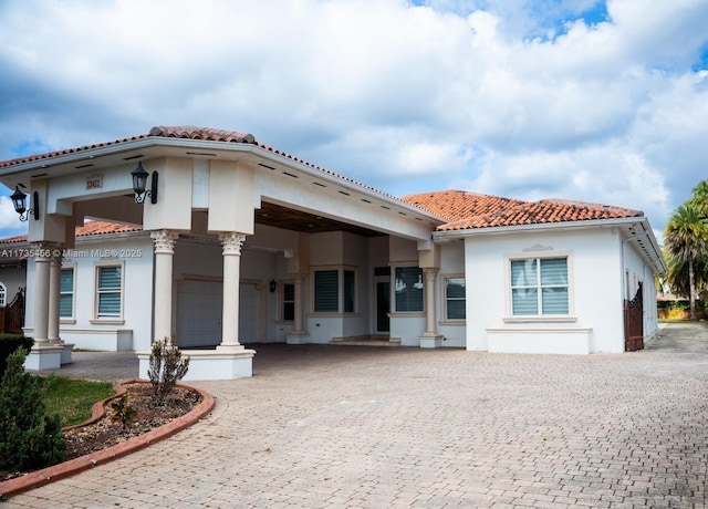 mediterranean / spanish-style home with a garage